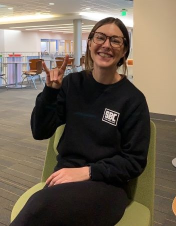 Alyssa, a student in the MSW program, sits in a green chair in the Student Union, and excitedly talks about the flexibility of her graduate program.