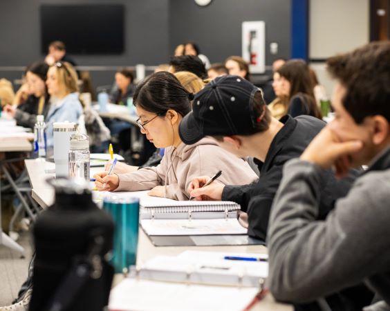 med students walk down the hospital hallway