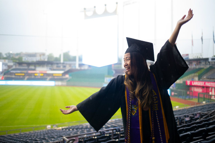 Female student flings out her arms.