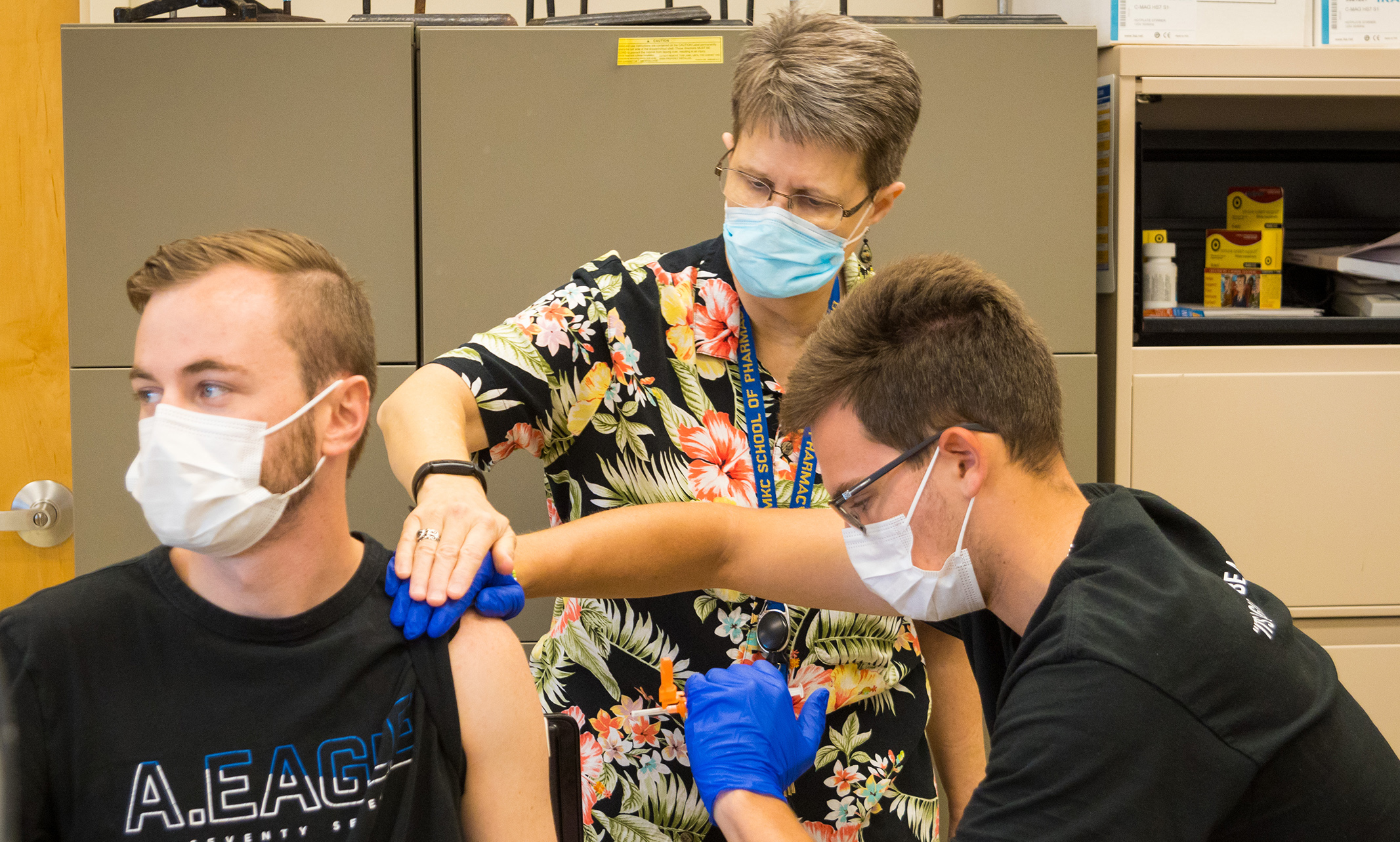 Pharmacy students receive instruction on how to give a shot