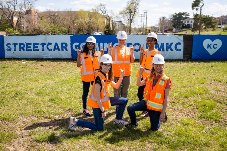 students in construction gear taking part in streetcar construction.