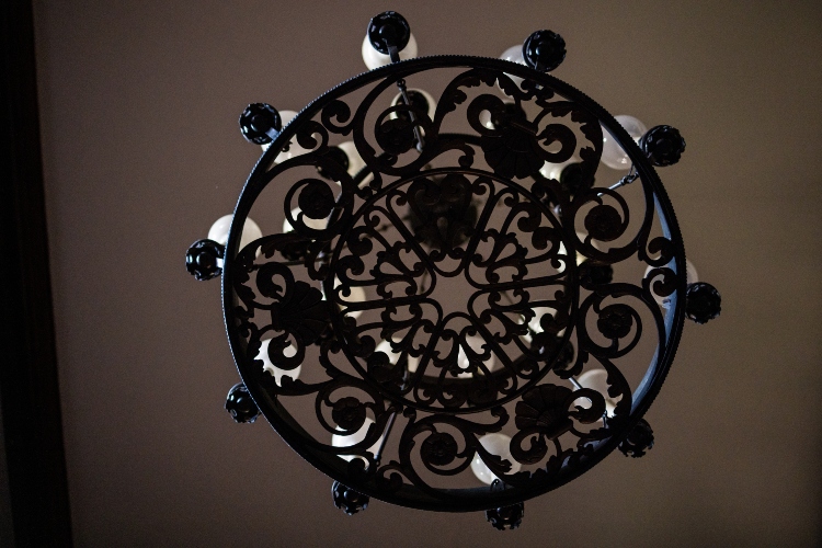 An upward view of a chandelier that is hanging from the ceiling 