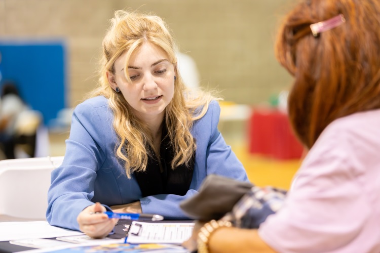 A medical student helps someone fill out a questionnaire