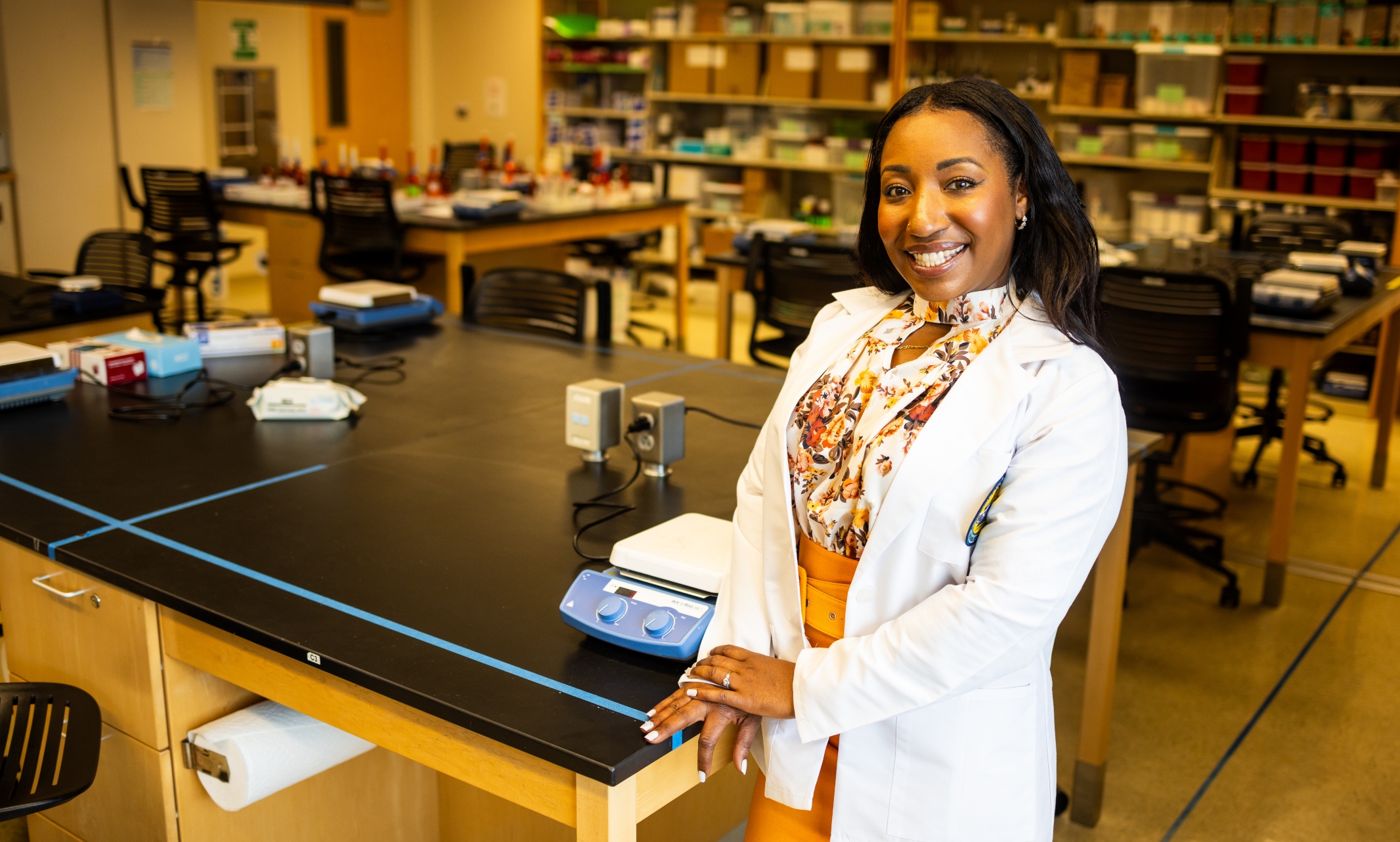 Leresa Cozart stands inside a Pharmacy lab