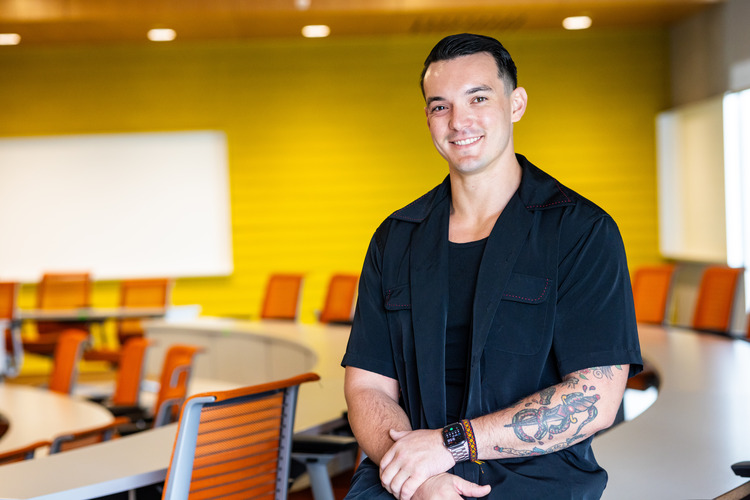 Charles McGraw standing in a classroom.