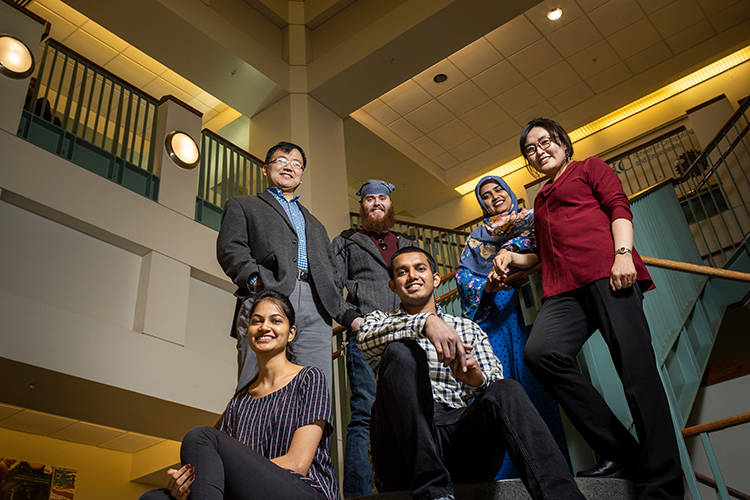 Students posing on a staircase