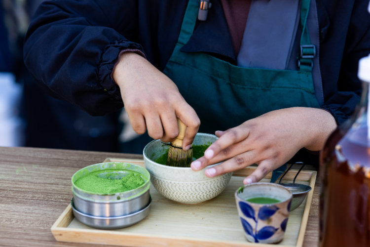 Yasmen Hassen whisks a matcha using a sifter and a matcha bowl.