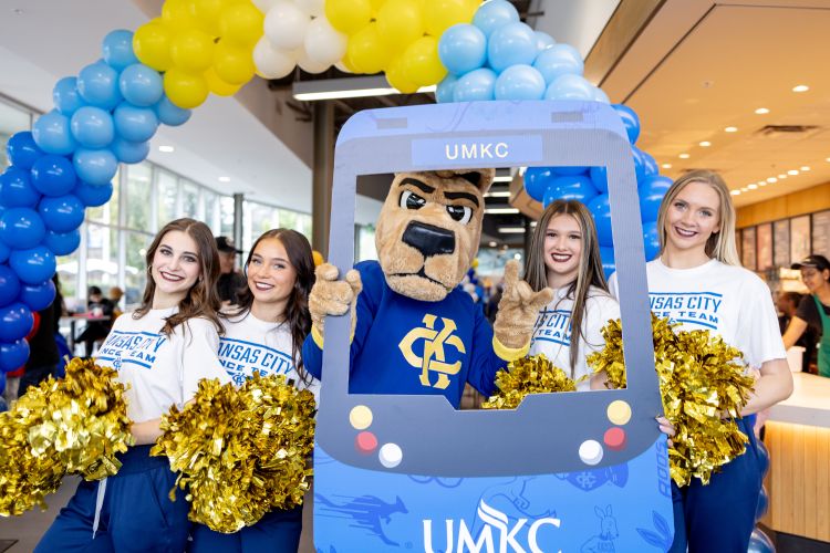 KC Roo stands with dance team