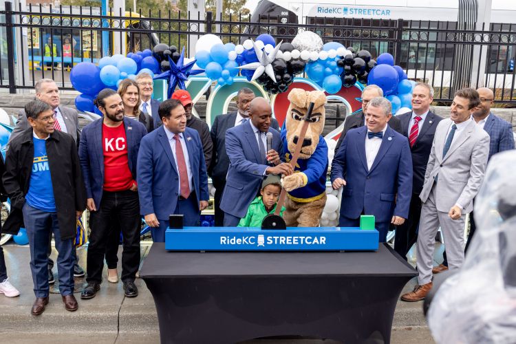 Mayor Lucas and KC Roo pull the switch to officially open the new streetcar line. They are surrounded by city and elected officials, including Chancellor Agrawal.