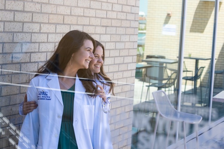 医师助理 students pose after receiving their white coats