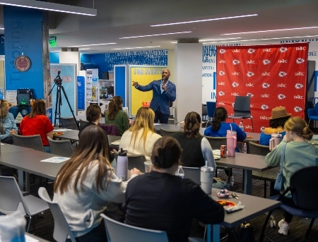 威尼斯人娱乐城 students listen as someone from the Chiefs organization shares information during a lunch and learn event.